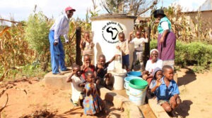 Group of people with water pump installed by The Africa Trust